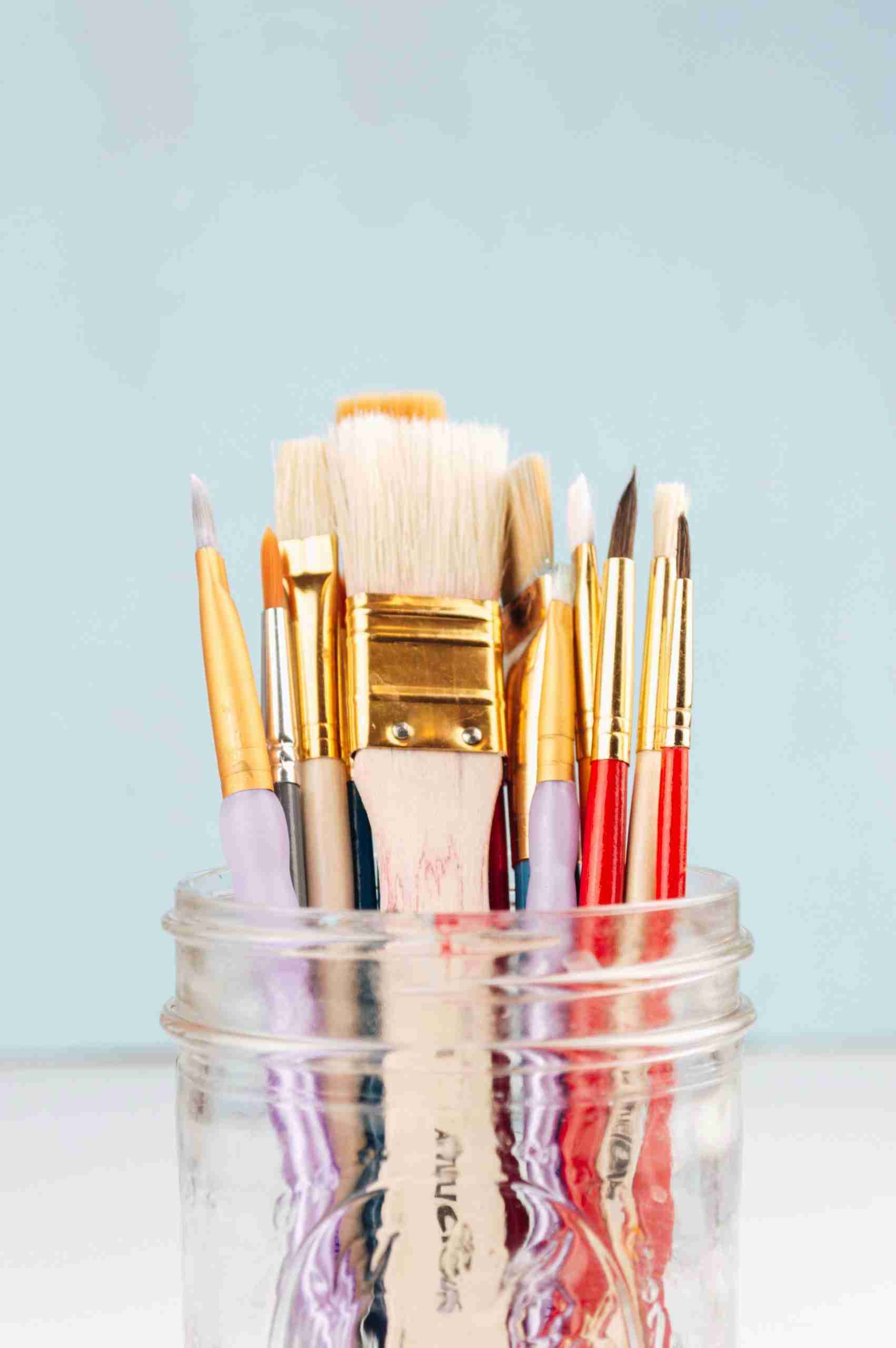 paintbrushes in a glass jar