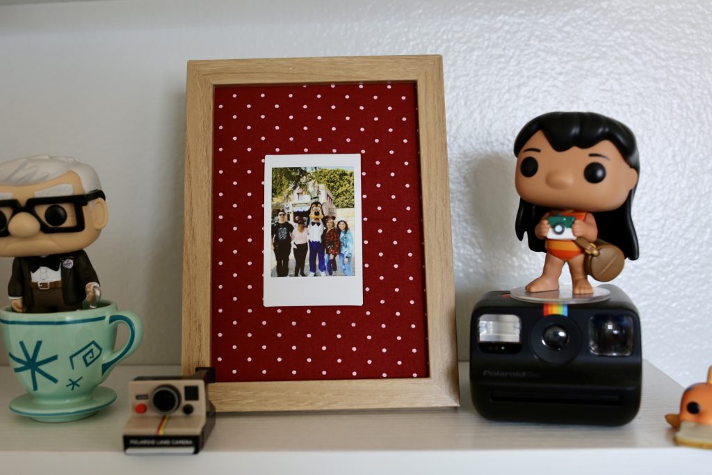 Photo frame with fabric lining and a polaroid photo
