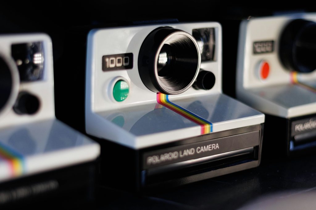 three polaroid cameras