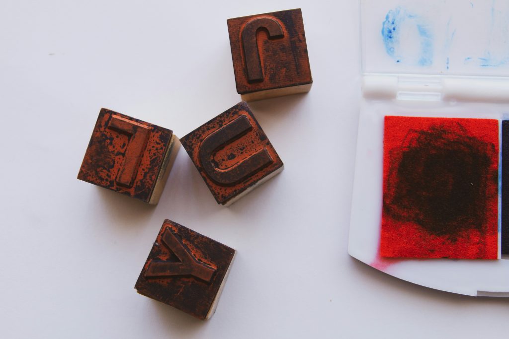 red ink pad with alphabet stamps