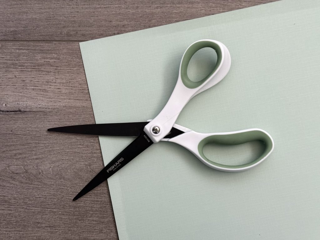 white and green fiskars scissors
