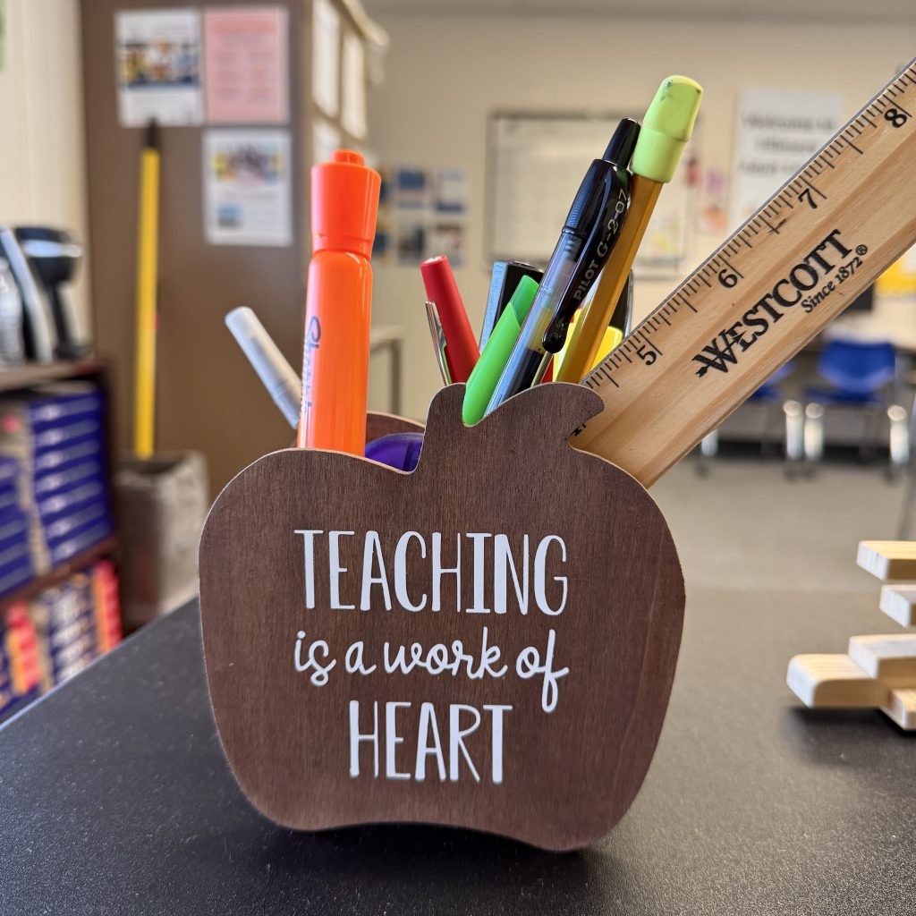 brown apple shaped pencil holder with quote