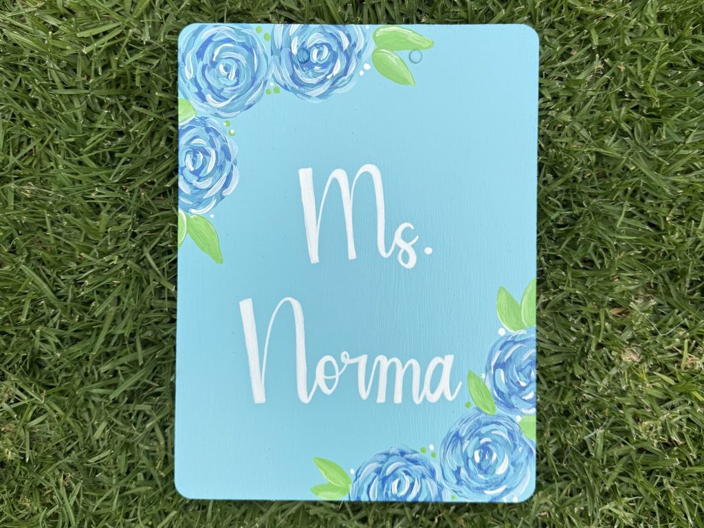 blue painted clipboard with flowers and name
