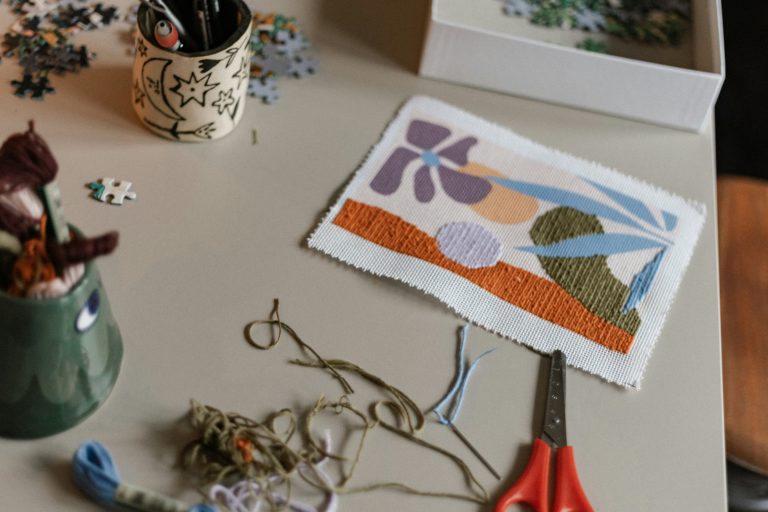 embroidery project on table with scissors and embroidery thread