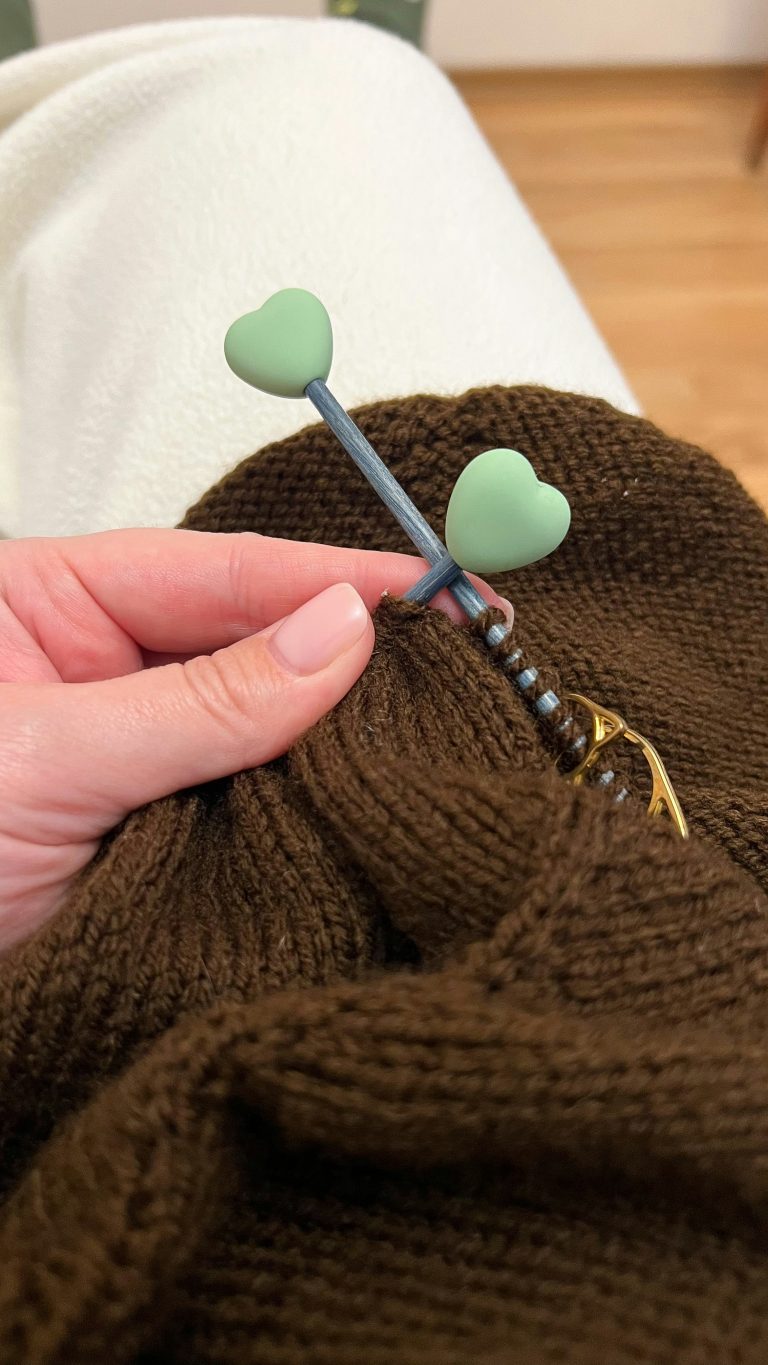 knitting brown sweater with heart needles