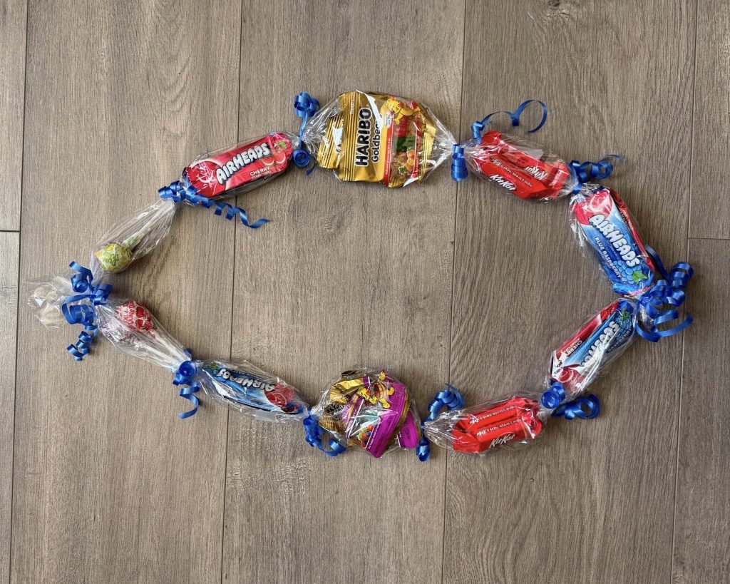 candy lei with blue ribbon 