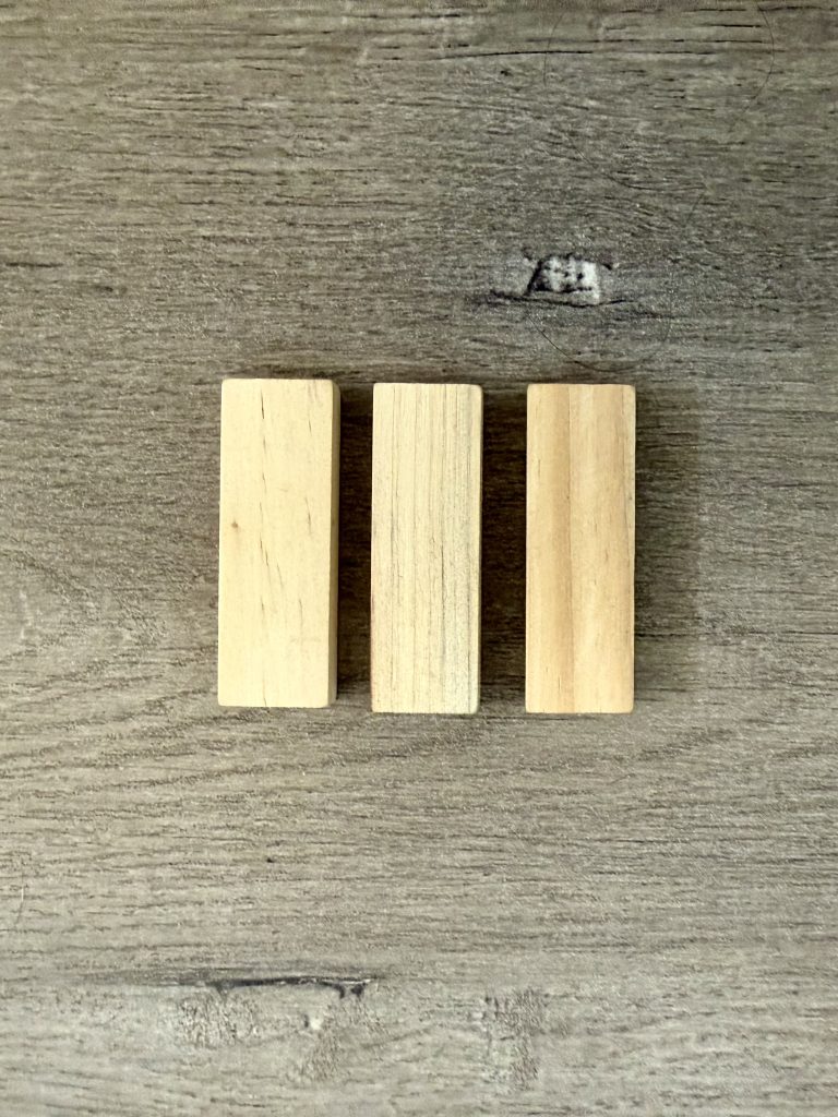 three mini jenga blocks