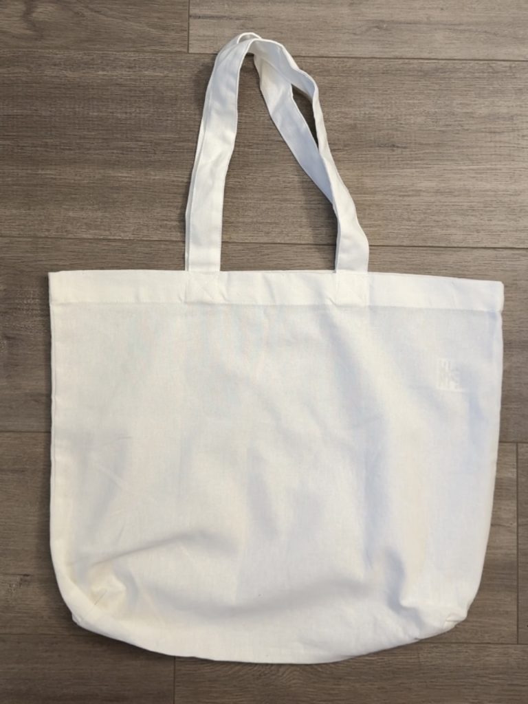 white tote bag on wooden surface