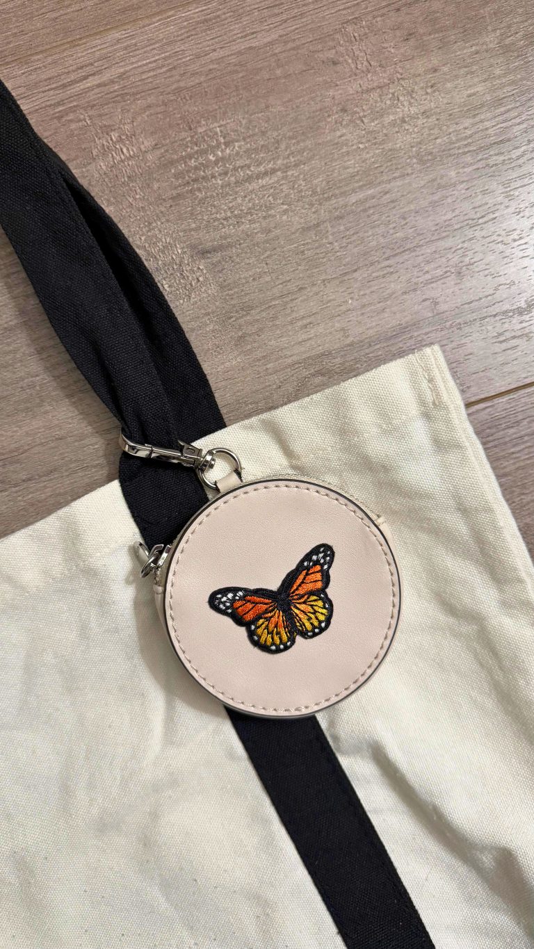 canvas tote bag with black straps and faux leather coin purse with butterfly patch