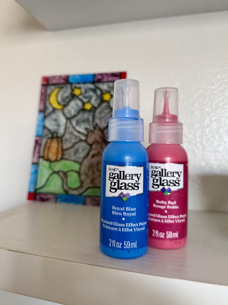 gallery glass paint bottles with painting in the back